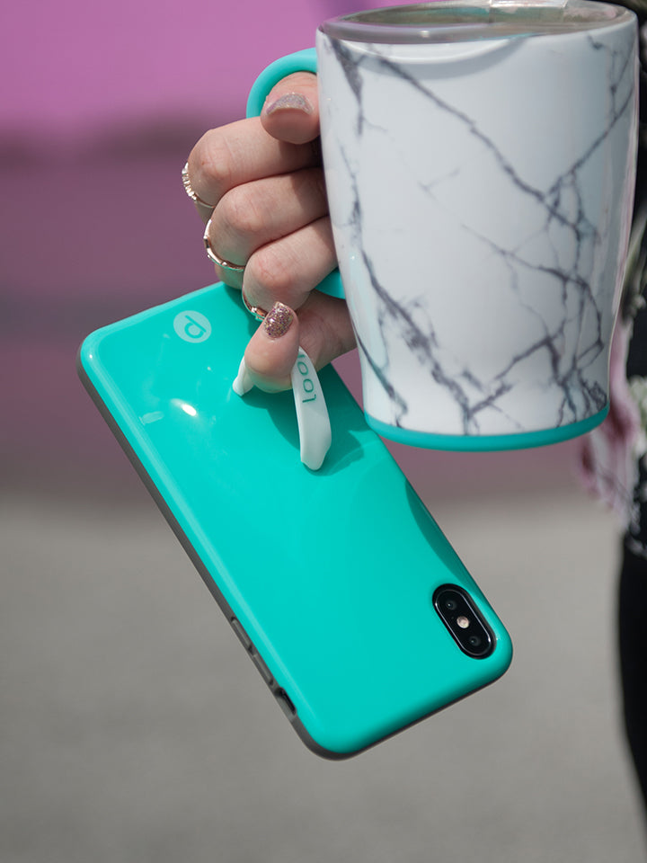  A woman holding a Turquoise Loopy Case.|| feature-media