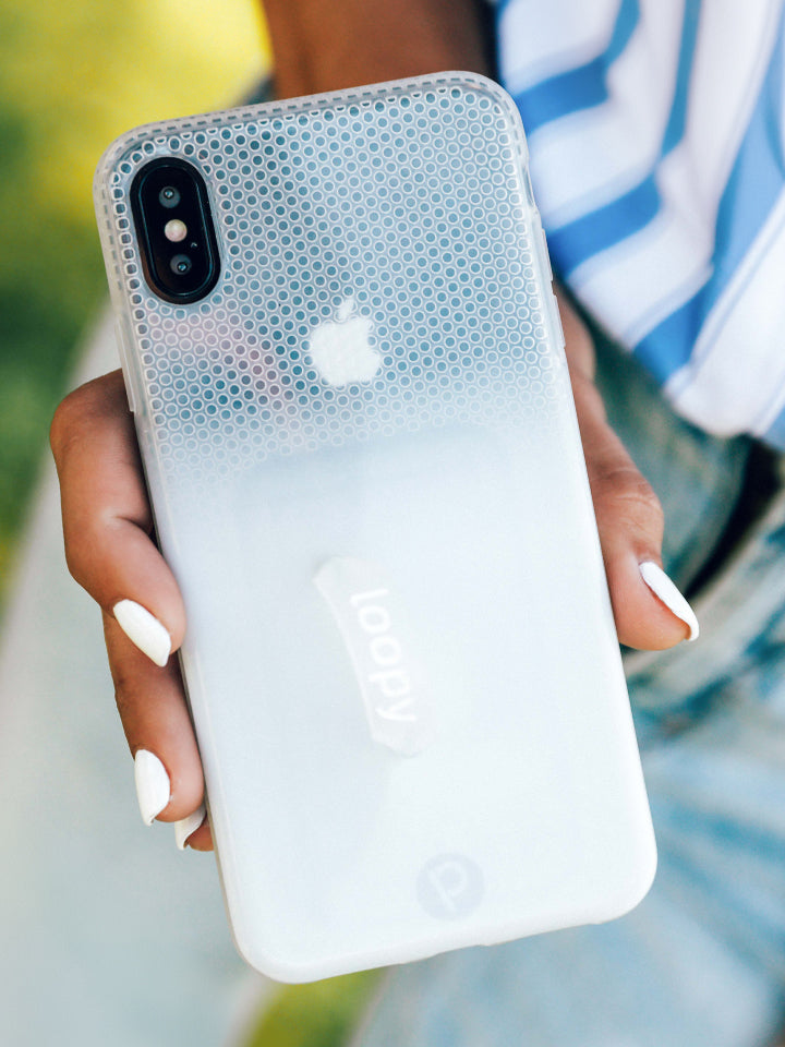 A woman holding a White Ombre Loopy Case. || feature-media