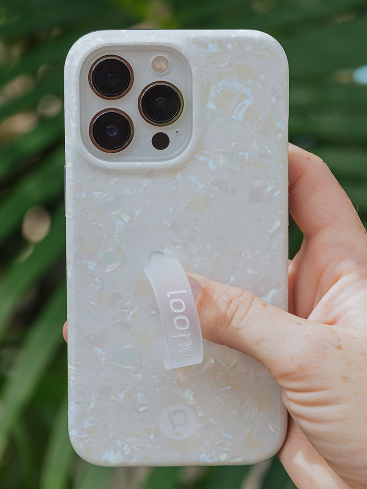 A woman holding a White Opal Shell Loopy Case.|| feature-media