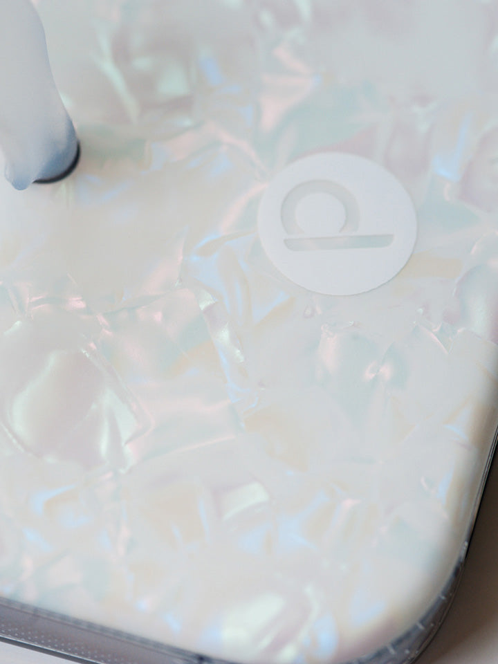 A close up of a White Opal Shell Loopy Case. || feature-media