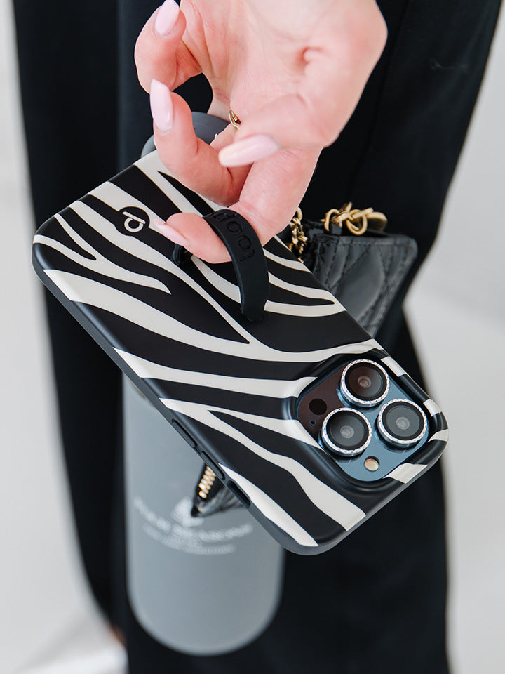 A woman holding a Zebra Loopy Case.|| feature-media