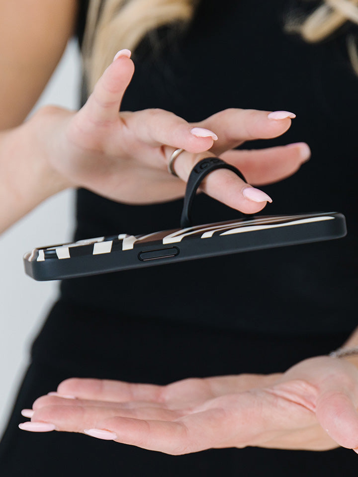 A woman holding a Zebra Loopy Case.|| feature-media