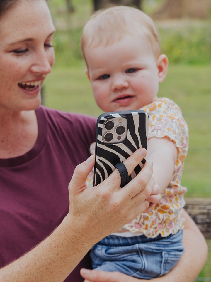 A woman holding a Zebra Loopy Case.|| feature-media