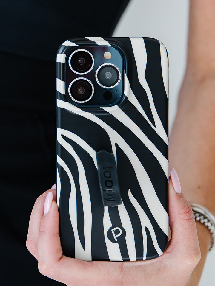 A woman holding a Zebra Loopy Case.|| feature-media