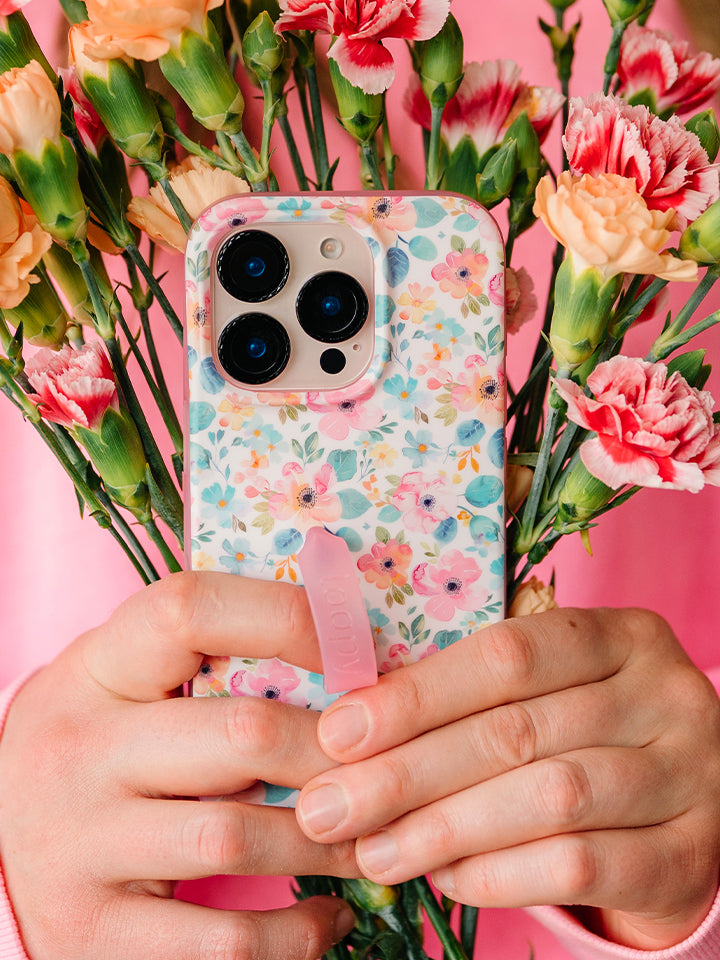 A woman holding a Pastel Petals Loopy Case. || feature-media