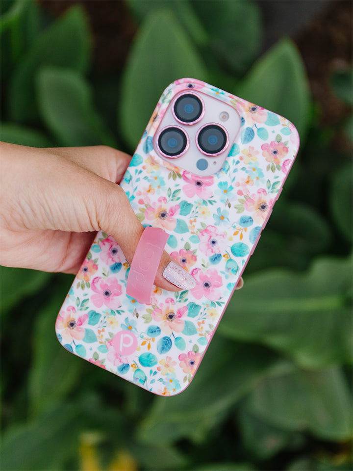 A woman holding a Pastel Petals Loopy Case. || feature-media