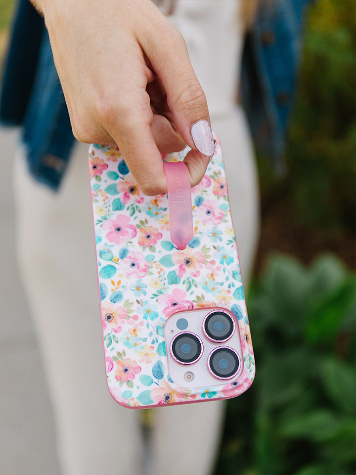 A woman holding a Pastel Petals Loopy Case. || feature-media