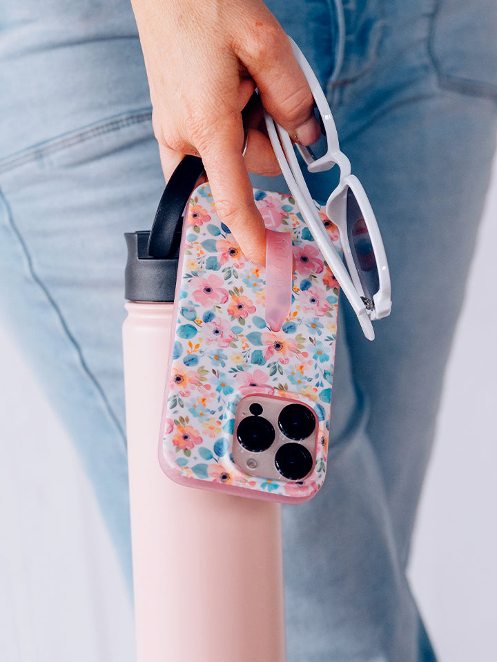 A woman holding a Pastel Petals Loopy Case. || feature-media