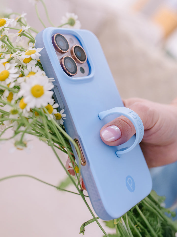 A woman holding a Sierra Blue Loopy Case. || feature-media