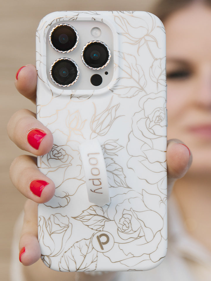 A woman holding an Enchanted Rose Loopy Case. || feature-media