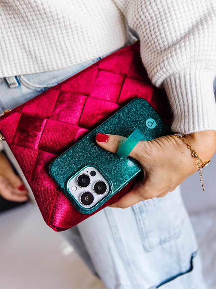 A woman holding and Emerald Sparkle Loopy Case.|| feature-media