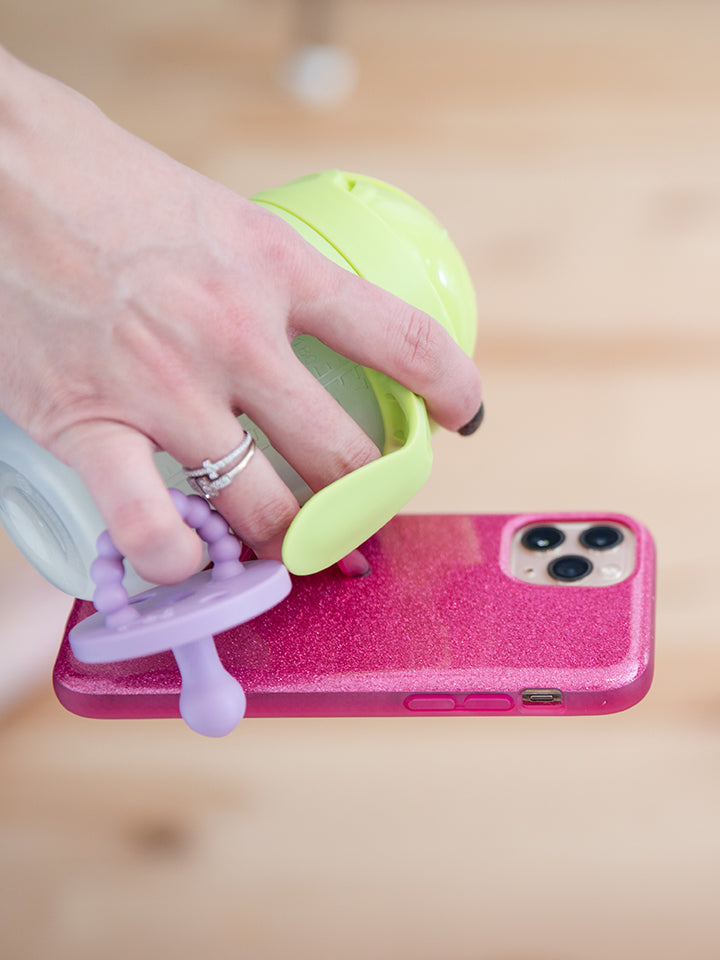 A woman holding a Sparkle Hot Pink Loopy Case.|| feature-media