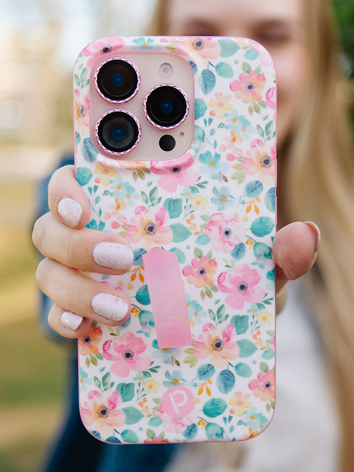 A woman holding a Pastel Petals Loopy Case. || feature-media