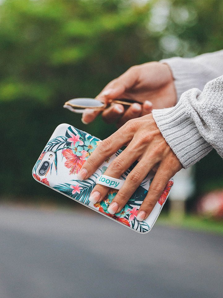 A woman holding a Tropical Hibiscus Loopy Case. || feature-media