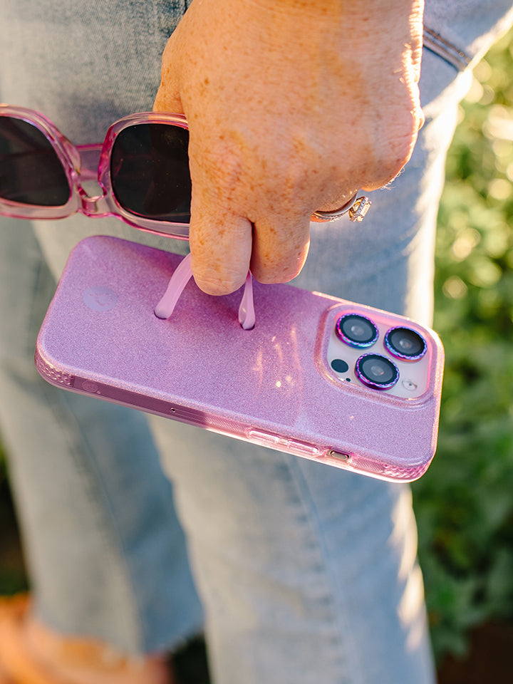 A woman holding a Lavender Sparkle Loopy Case. || feature-media