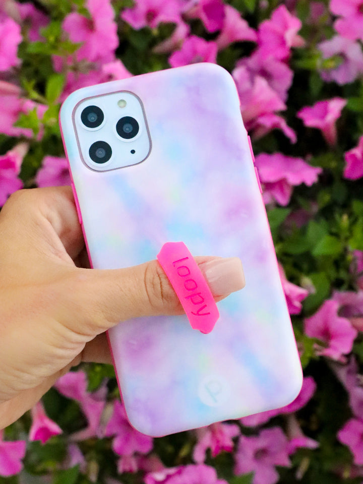 A woman holding a Tie Dye Loopy Case. || feature-media