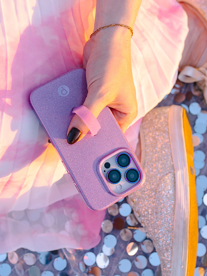 A woman holding a Lavender Sparkle Loopy Case. || feature-media