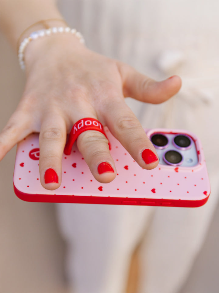 A woman holding a Be Mine Loopy Case. || feature-media