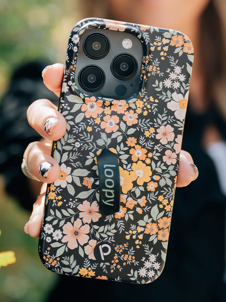 A woman holding a Vintage Blooms Loopy Case. || feature-media