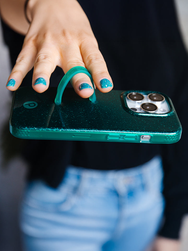 A woman holding an Emerald Sparkle Loopy Case.|| feature-media