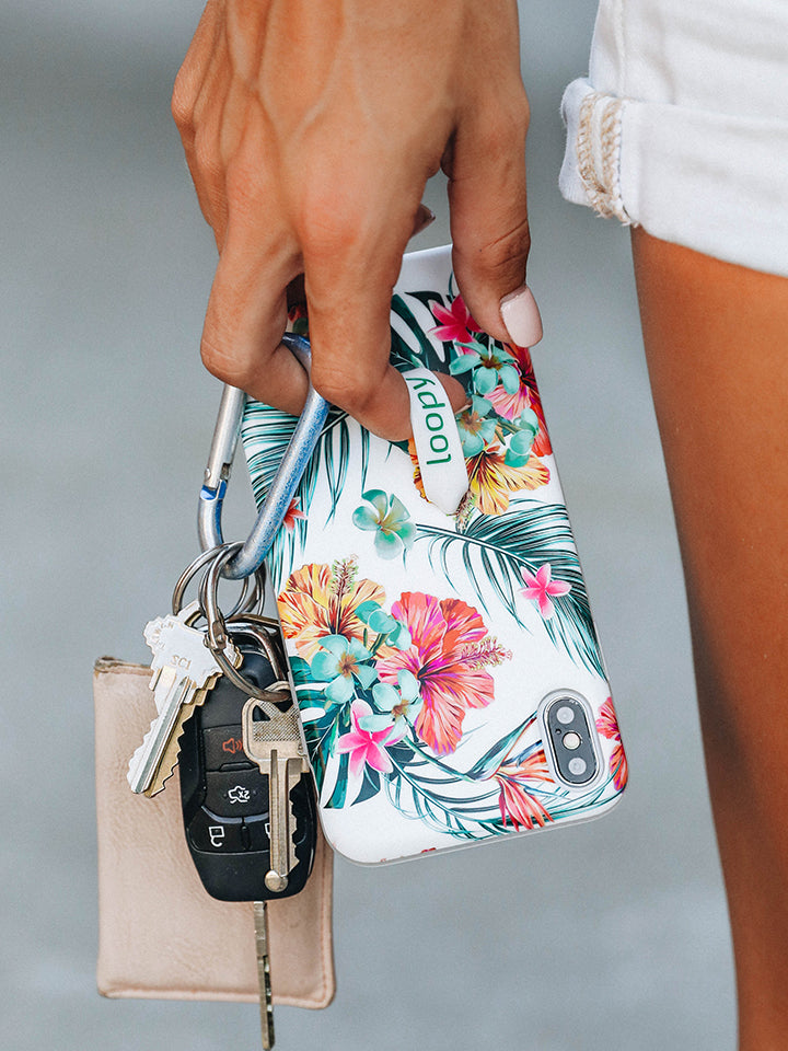 A woman holding a Tropical Hibiscus Loopy Case. || feature-media