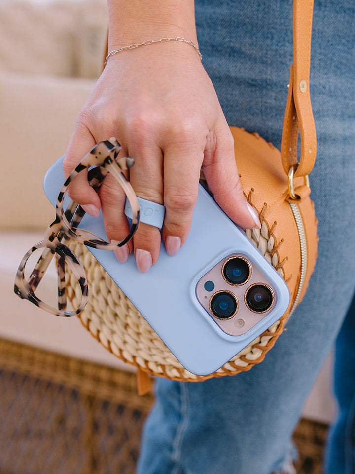 A woman holding a Sierra Blue Loopy Case. || feature-media