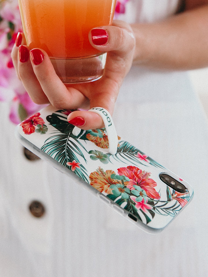 A woman holding a Tropical Hibiscus Loopy Case. || feature-media