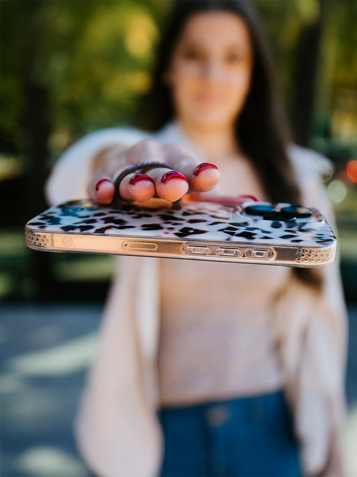 A woman holding a Blonde Tortoise Loopy Case. || feature-media