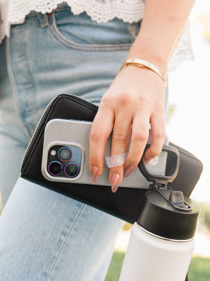 A woman holding a Platinum Sparkle Loopy Case.|| feature-media