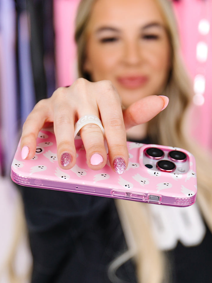 A woman holding a Blushing Boos Loopy Case. || feature-media