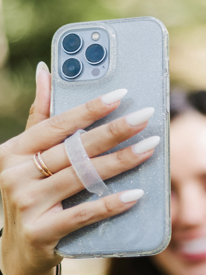 A woman holding a Clear Sparkle Silver Loopy Case.|| feature-media