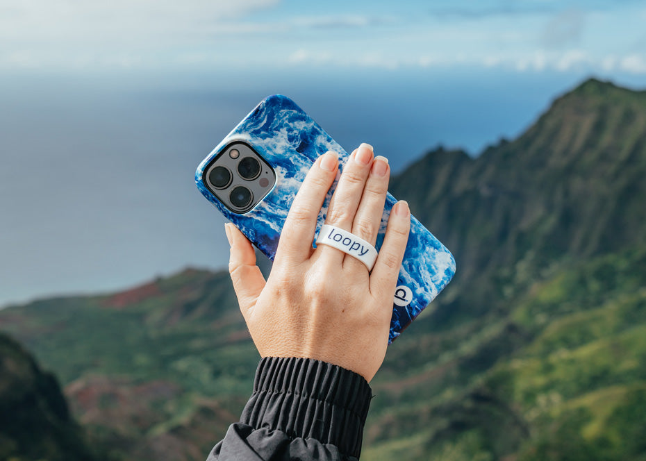 A woman holding an Ocean Loopy Case.