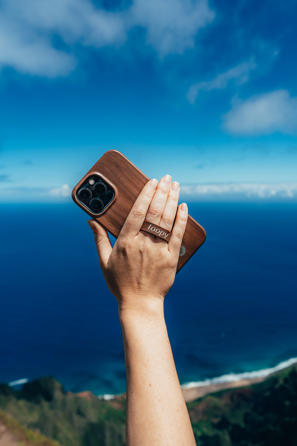 A woman holding a Teakwood Loopy Case.